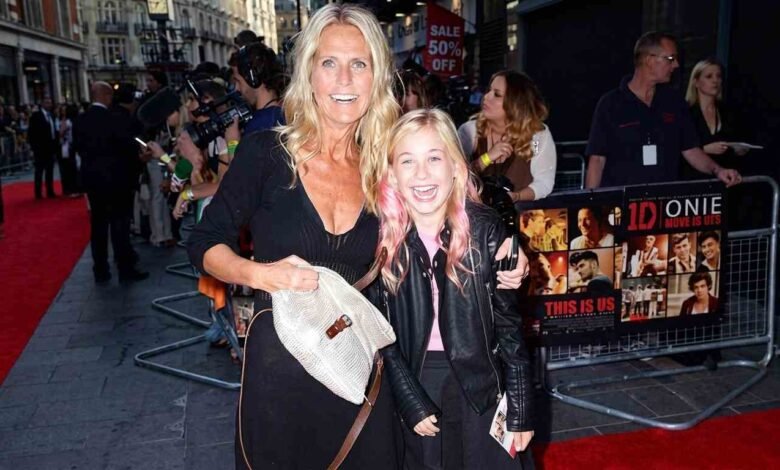 Ulrika Jonsson smiling on the red carpet with her daughter at a public movie premiere event.
