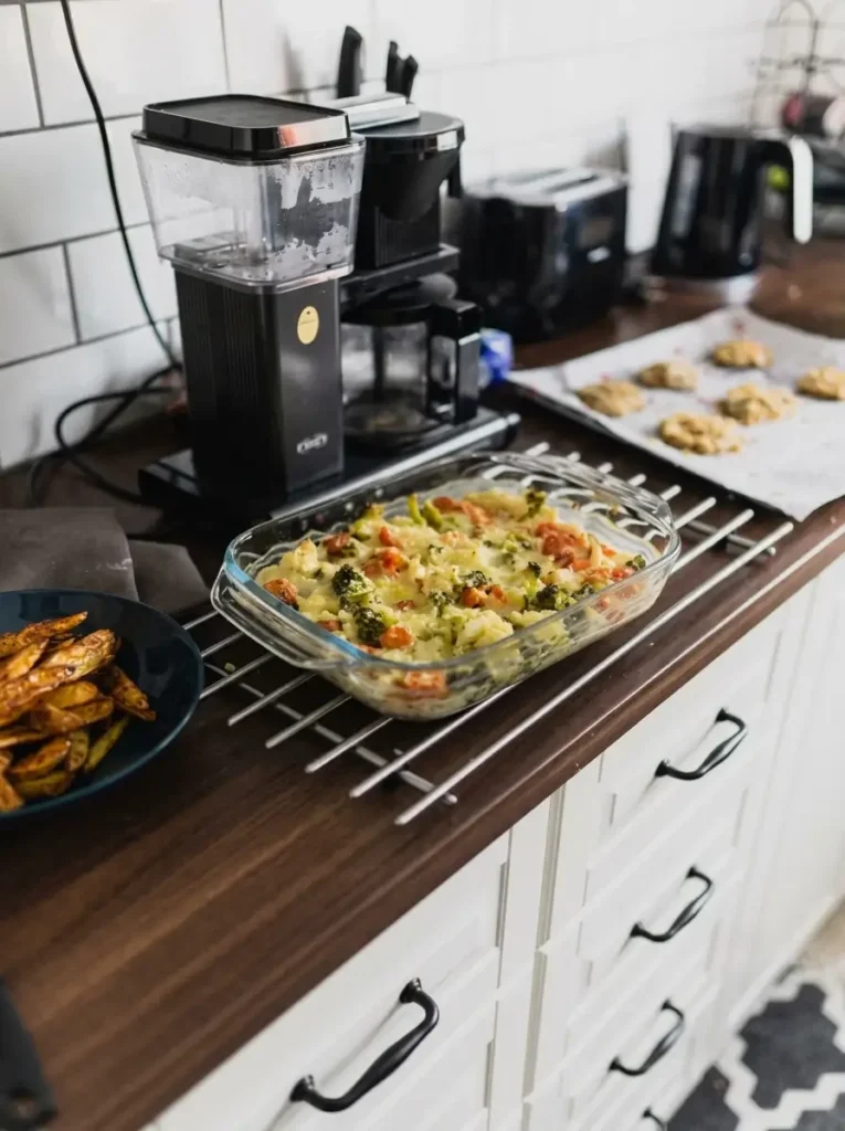 Freshly prepared home-cooked meal prep dishes on a wooden kitchen countertop.